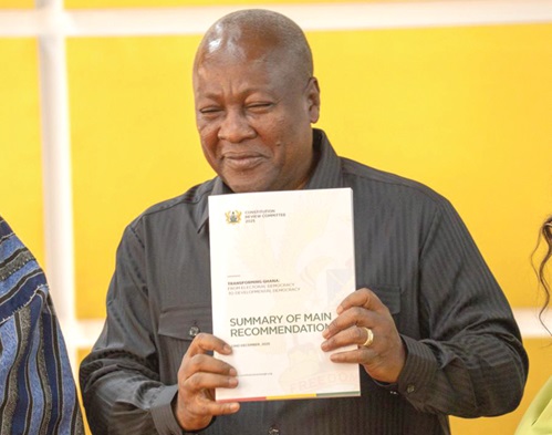 President John Mahama displaying a copy of the report