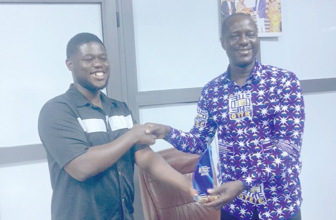  Professor Samuel Awinkene Atintono (right), Principal, Accra College of Education receiving the award from Daniel Botchway, outgoing President of NUGS