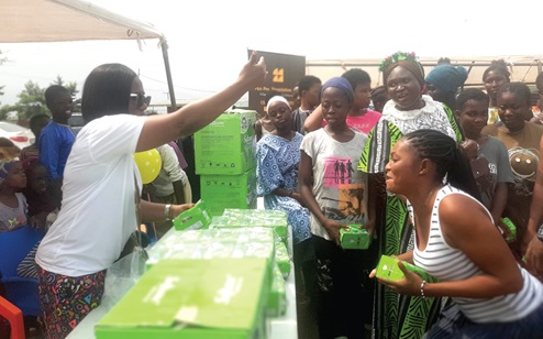 Peace Ocloo (left), Founder, Pax-Pee Foundation LBG, distributing sanitary pads to residents at Avornyo. Picture: ESTHER ADJORKOR ADJEI