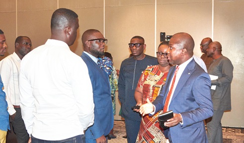 Kwesi Afreh Biney (right), Director-General, SSNIT, with Evelyn Adjei (2nd from right), Chief Actuary, SSNIT, explaining a point to some journalists after the event