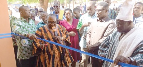 Dr Mark Kurt Nawaane (2nd from left) being supported by Dr Braimah Baba Abukari (left), Upper East Regional Director of Health Services, and Naab Bohagu  Samuel Namoog (right) to cut the tape. INSET: The new NHIS office