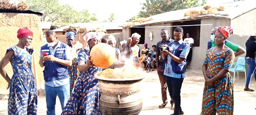 Members of the Bongo Lelingo Asongtaaba Parboilers Group demonstrating to the media how they steam rice while preserving its nutritional value