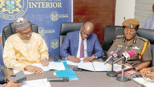 Muntaka Mohammed-Mubarak (left), Minister for the Interior, alongside Haruna Iddrisu, Minister for Education, and Patience Baffoe-Bonnie (right), Director-General of Prisons, signing the memorandum of understanding. Picture: ELVIS NII NOI DOWUONA 