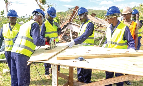 A team of Ghanaian and Jamaican soldiers working on one of the homes