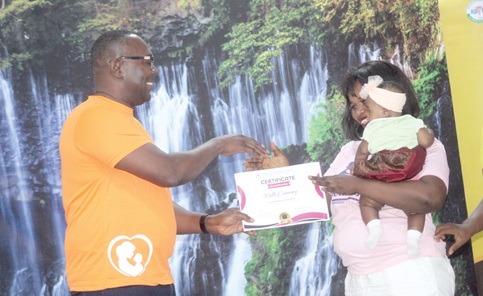 Dr Charles Takyi (left), Consultant Obstetrician-Gynaecologist, presenting a certificate to Ruth Commey for completing the Korle Bu Mothercraft Programme. Picture: ESTHER ADJORKOR ADJEI
