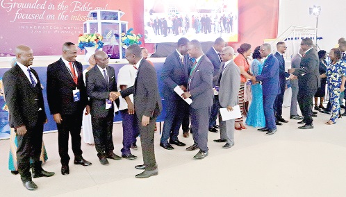 Dr Timothy Yeboah (2nd left) exchange greetings with the South West President Pastor Yaw Kwakye Adeefe at Kweikrom Adventist Camp Site in the Central Region as the old executive hands over to the new team