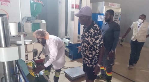 Franco Obour(right), Managing Director, Franco Food Processing and Farms, supervising a worker  bagging some of  the locally produced rice.