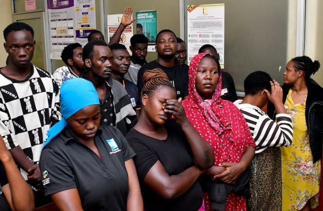 Suspects arrested for public nuisance, inciting violence and obstructing police officers during the recently concluded general elections stand at the City Hall Magistrate’s Court, where they were charged, in Kampala, Uganda, January 19, 2026. REUTERS/Abubaker Lubowa