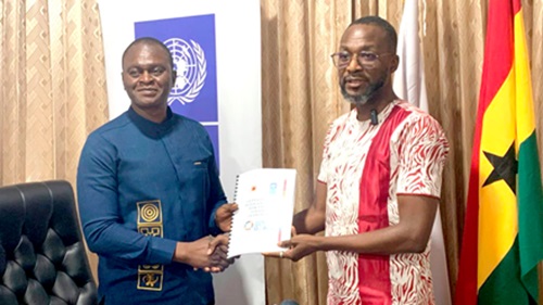 Major (Rtd) Dr Joseph Bikanyi Kuyon (left), Director-General of NADMO, receiving the National Disaster Management and Risk Financing Strategy Framework and Implementation Plan 2025-2030 from Dr Abdul-Razak Saeed (right), Head of Environment and Climate at UNDP Ghana