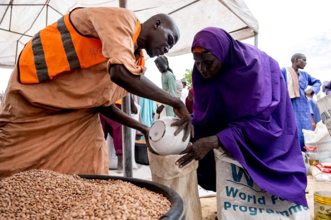 Yaanama Abba, a 45-year-old mother of six children, receives pinto beans distributed by WFP in Mafa LGA, Borno State, Nigeria, July 16, 2025. Damilola Onafuwa, WFP Nigeria Communications Service/Handout via REUTERS/File Photo
