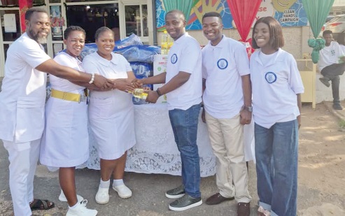Seth Armah (3rd FROM right), a representative of MCF, handing over the items to Lawrencia Akweley Turkson, Senior Nurse at Child Health Department, Korle-Bu