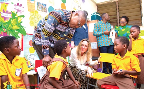 Dr Clement Apaak (bespectacled), Deputy Education Minister, and Lavinia Jacobs-Hodson (holding card), Chairperson of the Board of Trustees, Jacobs Foundation, interacting with pupils during the tour. 