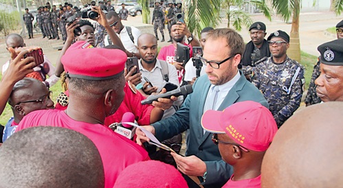 Bernard Mornah (back to camera), lead convenor, Arise Ghana, presenting the petition to a representative of the US Embassy. Picture: ERNEST KODZI 