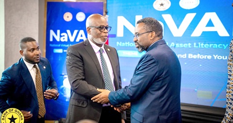 Dr Johnson Pandit Asiama (right), Governor, Bank of Ghana, in a handshake with Dr James Klutse Avedzi, Director-General, Securities and Exchange Commission, at the launch of the National Virtual Asset Literacy Initiative