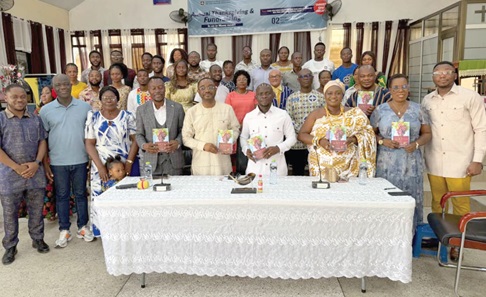 Albert Amedzro  (4th from left), President of SROM; Wisdom Woyome (5th from left), former MP for South Tongu,  and other attendees displaying the newly launched book. Picture: SAMUEL OHENE EWUR.
