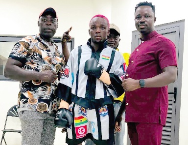 George Faho Mensah (middle) with trainer Emmanuel Annor Yeboah (left) and the promoter Samuel Agyei Darkwah of SP Sport Promotions