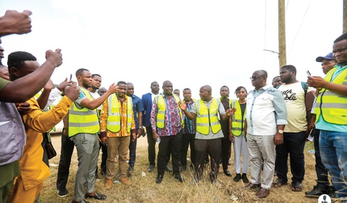 Kofi Modzaka (with hands raised), Technical  Supervisory Consultant at GIDA, explaining the extent of work to Eric Opoku (middle), Minister of Food and Agriculture, and his entourage during the visit
