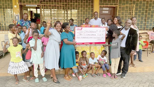 Kunle Olutimehin (right), CEO of MSC, presenting a dummy cheque to Mary Bentil, a social worker at Osu Children’s Home