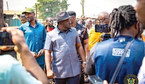 Dr Frank Amoakohene, Ashanti Regional Minister, observing the extent of damage during a visit to the scene