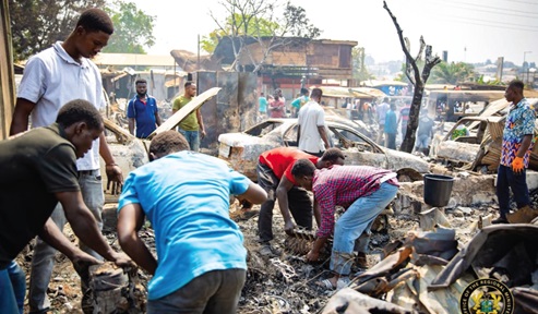  Some mechanics trying to salvage some items after the fire was brought under control.