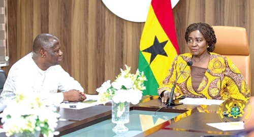 Prof. Naana Jane Opoku-Agyemang, Vice-President, engaging Emmanuel Armah-Kofi Buah (left), Minister of Lands and Natural Resources, during her visit to the ministry