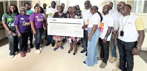 Members of DBG Team B presenting a dummy cheque to clear the bills of some new mothers at the Korle Bu Teaching Hospital