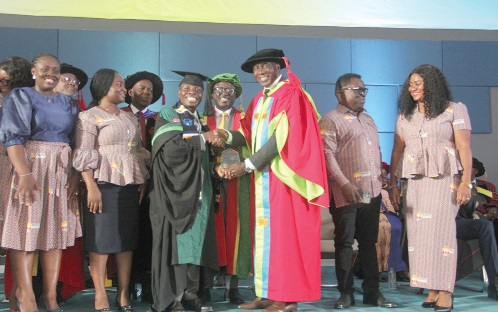 Dr Samuel Amo Tobbin (3rd from left), Chancellor of the Entrance University of Health Science, presenting the Overall Best student award to Dr Daniel Osafo