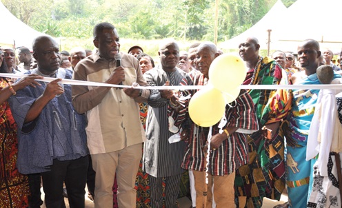 Governs Agbodza (holding mic), Minister of Roads and Highways; Ahmed Ibrahim (3rd from left), Minister of Local Government, Chieftaincy and Religious Affairs; Togbe Gbogbi Atsa V, Paramount Chief of Adaklu; James Gunu (left), Volta Regional Minister, jointly cutting the tape to open the building. RIGHT: The Adaklu Traditional Council office building at Adaklu-Abuadi