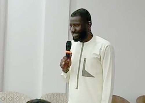 Abukari Abdul-Mumin (right), Programmes Manager of MSIG, presenting an overview of the Youth For Health project at the close-out ceremony while stakeholders listen