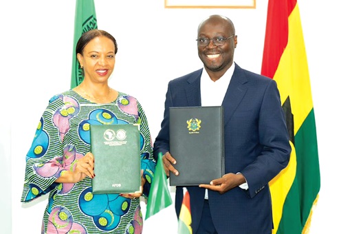 Dr Cassiel Ato Forson (right), Minister of Finance, and Eyerusalem Fasika, AfDB’s outgoing Country Manager in Ghana, displaying the signed agreement