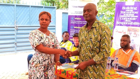 Prof. Yaw Fosu-Kusi (right), Board Chair of NADeF, presenting an award to one of the beneficiaries