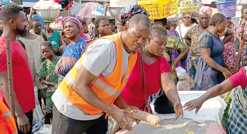 A municipal officer (2nd from left) trying to push some of the traders back to make way for pedestrians