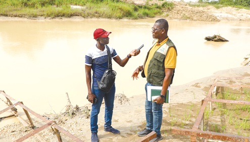 Ernest Adofo, Manager, Bekwai Forest Services Division, explaining the devastation caused by illegal miners. 