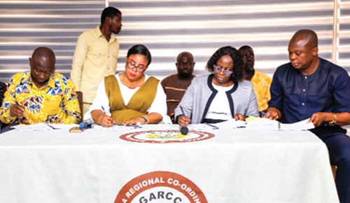 Linda Akweley Ocloo (2nd from left), Greater Accra Regional Minister, together with Samuel Tetteh Quarshie Morton (left), Municipal Chief Executive, Kpone Katamanso Municipal Assembly, and the members of the Greater Accra Regional Coordinating Council signing the performance contract. Picture: ELVIS NII NOI DOWUONA 