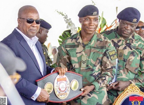 Jerry Lartey presenting his WBA International Super Lightweight title to President John Mahama (left) during the recent WASSA event at Burma Camp, Accra