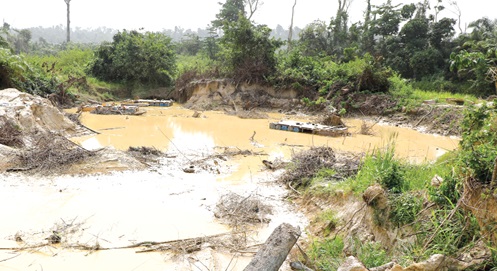 A section of the Oda River Forest Reserve reduced to a gapping pit by illegal miners.