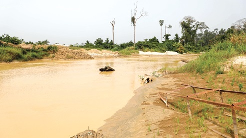 Oda River in the Bekwai Forest District turns brown from mining pollution.