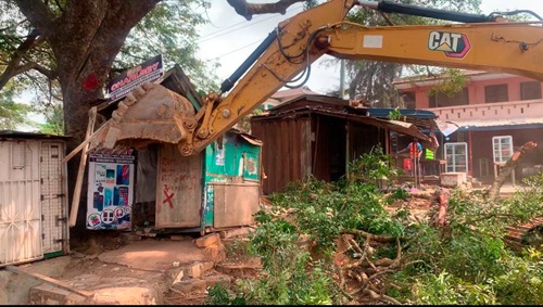 An excavator clearing some stores to make way for the project to continue