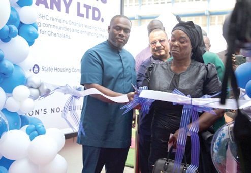 Hannah Sarpong (right), wife of late Dr. Samuel Sarpong, assisted by Kenneth Gilbert Adjei (left), Minister of Works and Housing, to cut the tape to inaugurate the 24hr Premium and Express Service Centre. Picture: CALEB VANDERPUYE