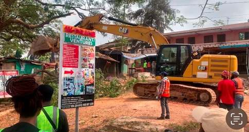 A supervisor overseeing the demolishing of kiosk and shops