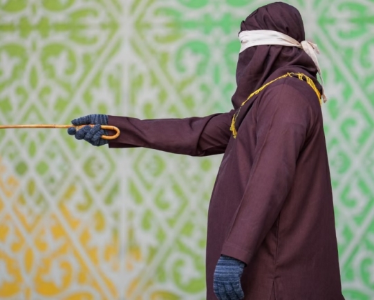 A robed and hooded official prepares to flog a Sharia law violator in Banda Aceh, Indonesia on Thursday. Photograph: Muhammad Iqbal/Zuma Press Wire/Shutterstock