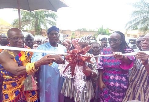 Haruna Iddrisu (2nd from left), Minister of Education, being assisted by Dr Paul Kofi Fynn (2nd from right), Chancellor, Winsconsin International University College, and Prof. Rita Akosua Dickson (right), VC, KNUST, to cut the tape to inaugurate the new students’ hostel