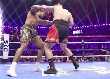 Anthony Joshua (left)  lands a blow to the body of Kristian Prenga during the fight