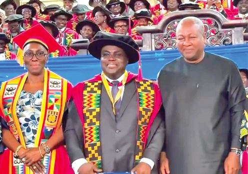 Dr Julius Debrah (middle) joined by President Mahama and Marietta Brew (left), Chairperson, Governing Council of the University of Ghana, after receiving his PhD at the graduation