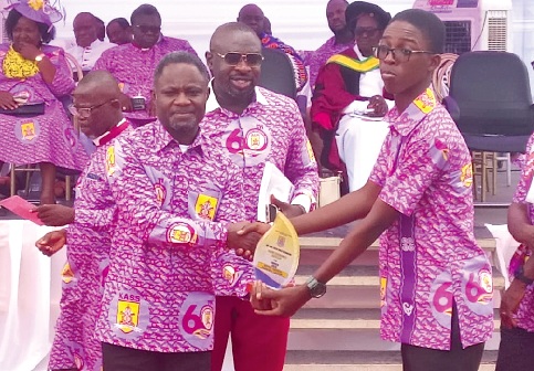 Kwabena Mintah Akandoh (left), Minister of Health, presenting the Best Art and Design Studio Award to Avukpor Kelvin Selassi during the event
