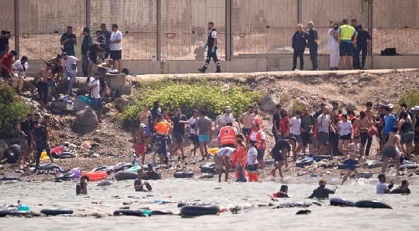Nine dead as thousands of migrants enter Spanish enclave from Morocco