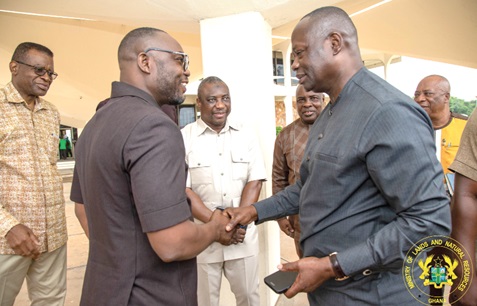 Emmanuel Armah-Kofi Buah (right), Minister of Lands and Natural Resources, interacting with Robert Makila Sambian, CEO, VALCO 