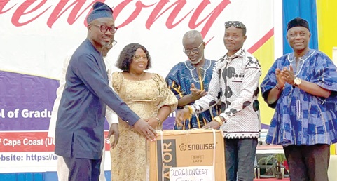 Prof. Denis Worlanyo Aheto (left), Vice Chancellor of the University of Cape Coast, presenting a tabletop refrigerator to Kojo Bosomtwe, the longest service retiree 