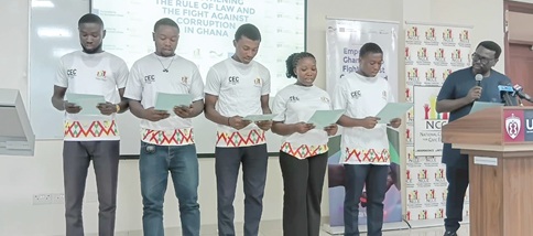 Dr Victor Brobbey (right), Deputy Chairman in charge of General Services at the NCCE, swearing in the executive of CEC UNIMAC 