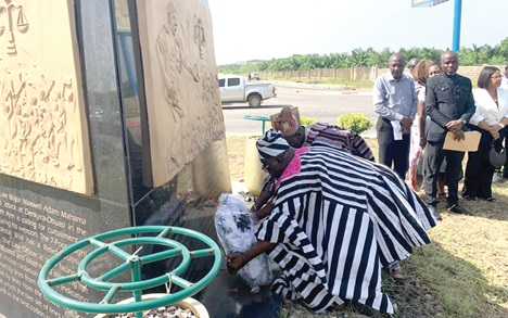 Captain (retd) Dennis Mahama Adam, who is also the Gbampeywura of the Bole Traditional Area, laying a wreath at the bust of his son at the roundabout named after the late Major Maxwell Adam Mahama